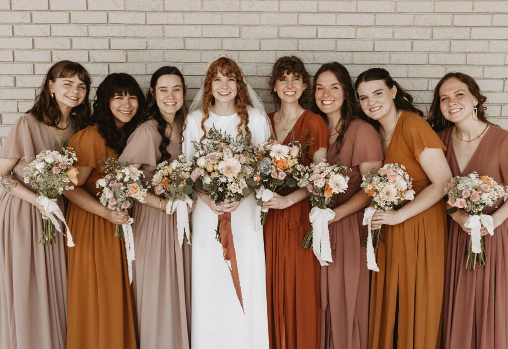 Burnt orange, marigold/saffron, rosy brown, and taupe themed bridal party.