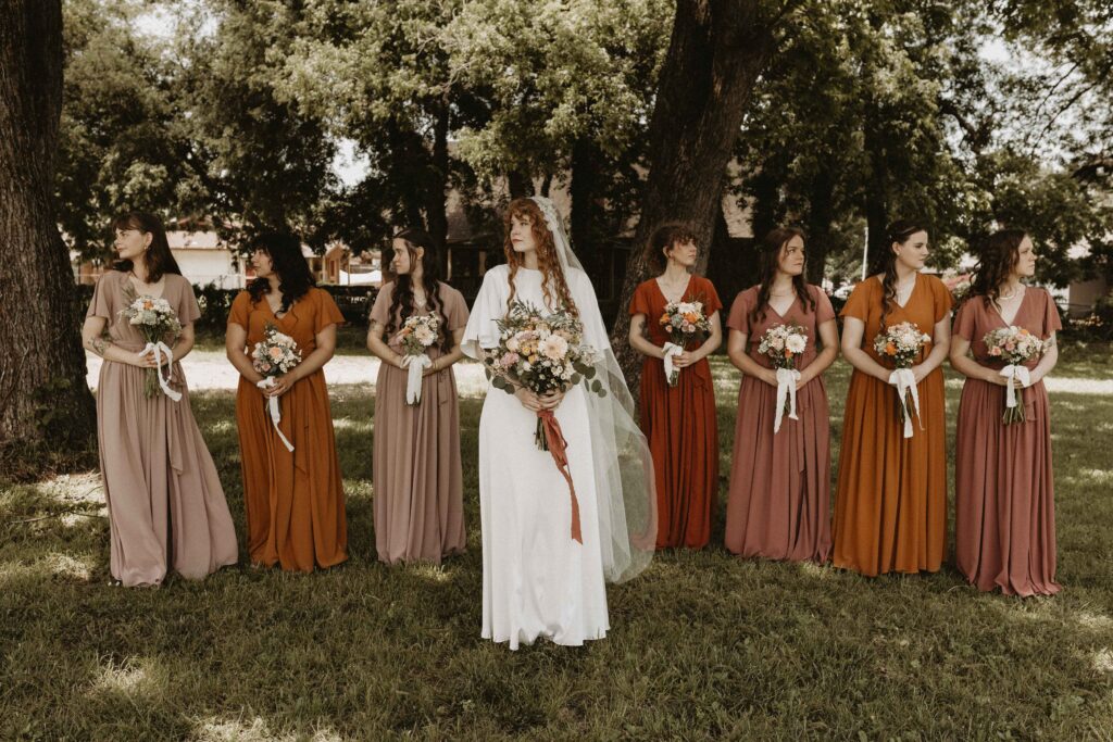 Burnt orange, marigold/saffron, rosy brown, and taupe themed bridal party.