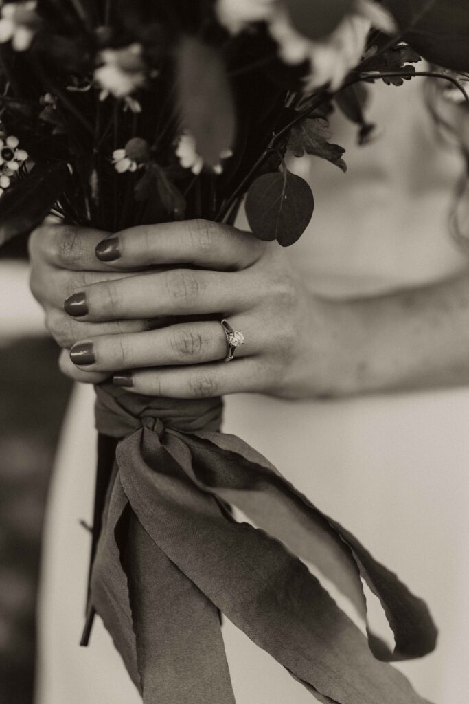 Details image of a bride holding her bouquet. 