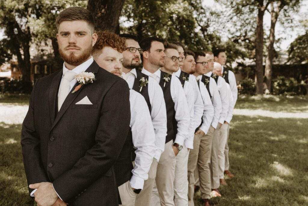 Groomsmen stacked in a serious pose.