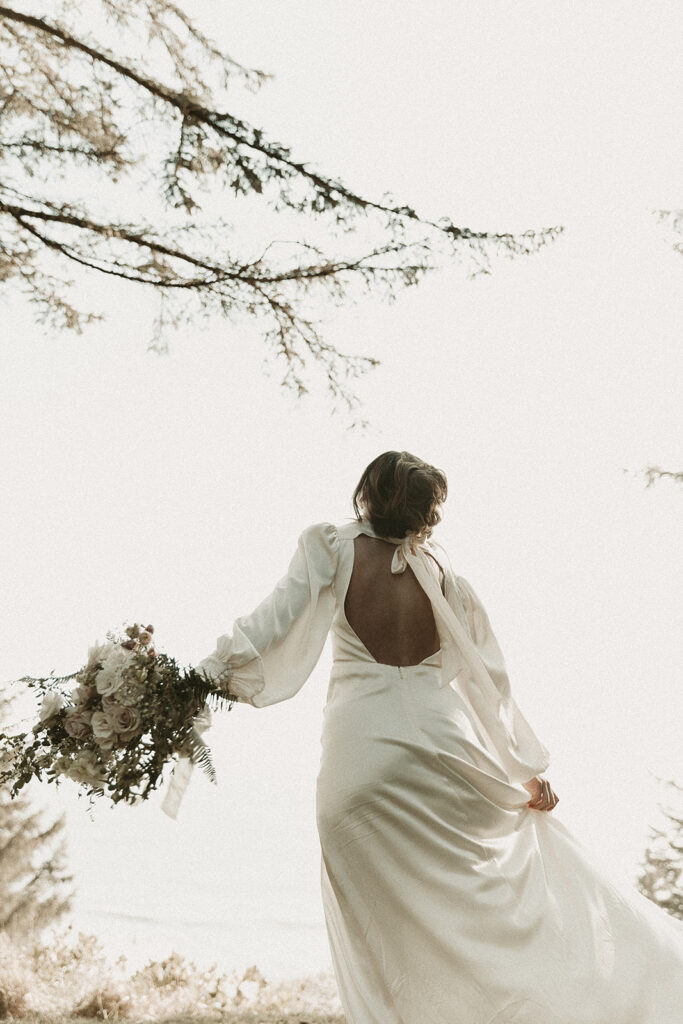 Bride twirls amongst the trees during their dreamy Crook Point elopement in Oregon.