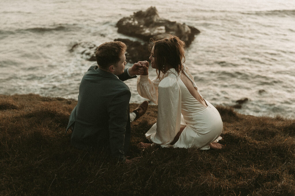 Bride and groom look into each other's eyes during dreamy sunset cliff elopement photos at Crook Point, Oregon.