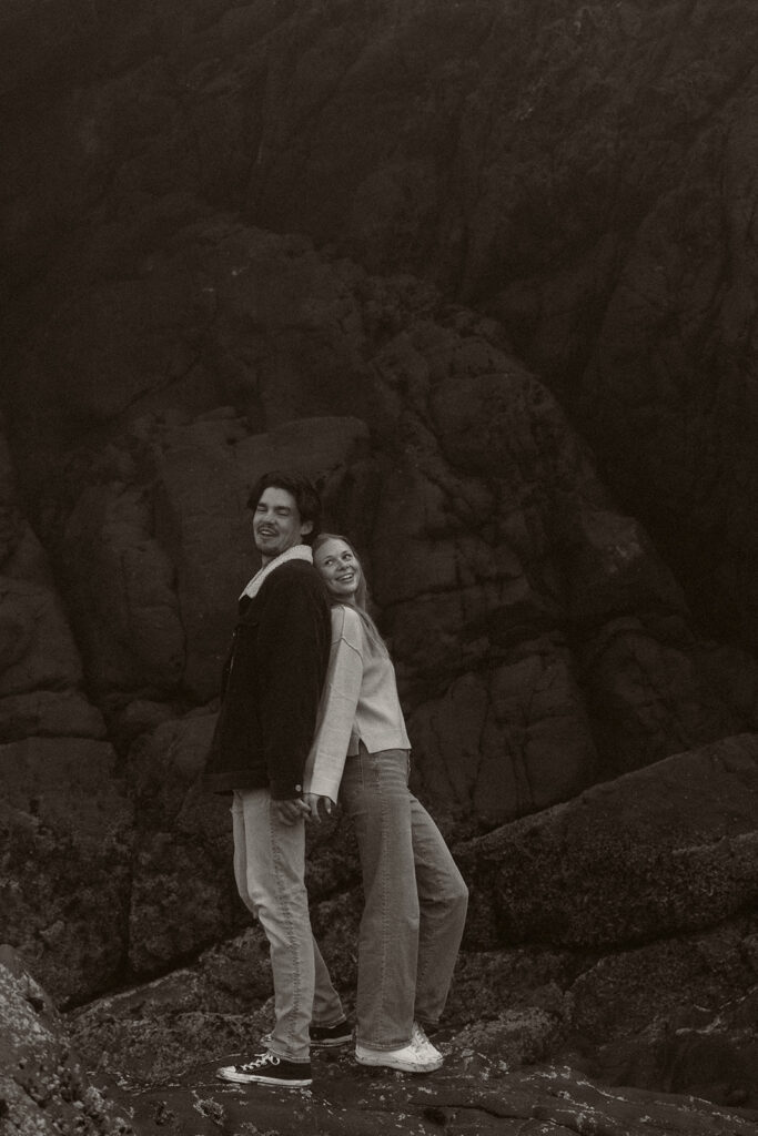 Young couple explores sea stack at Gold Beach, Oregon.