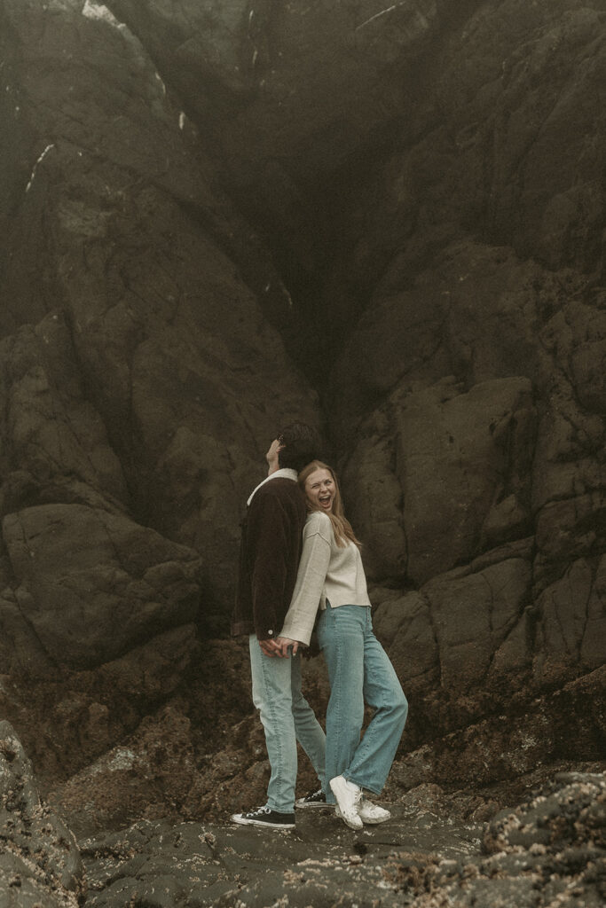 Young couple explores sea stack at Gold Beach, Oregon.