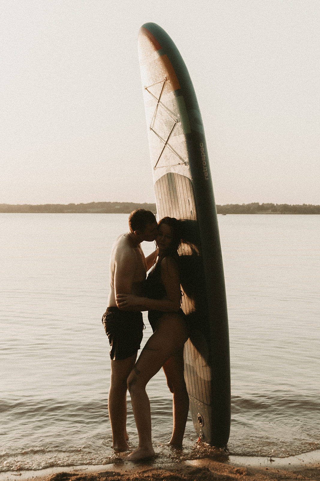 Young couple has a summer lifestyle photoshoot at Smithville Lake, Missouri, with their paddle boards and yellow lab, Doc.