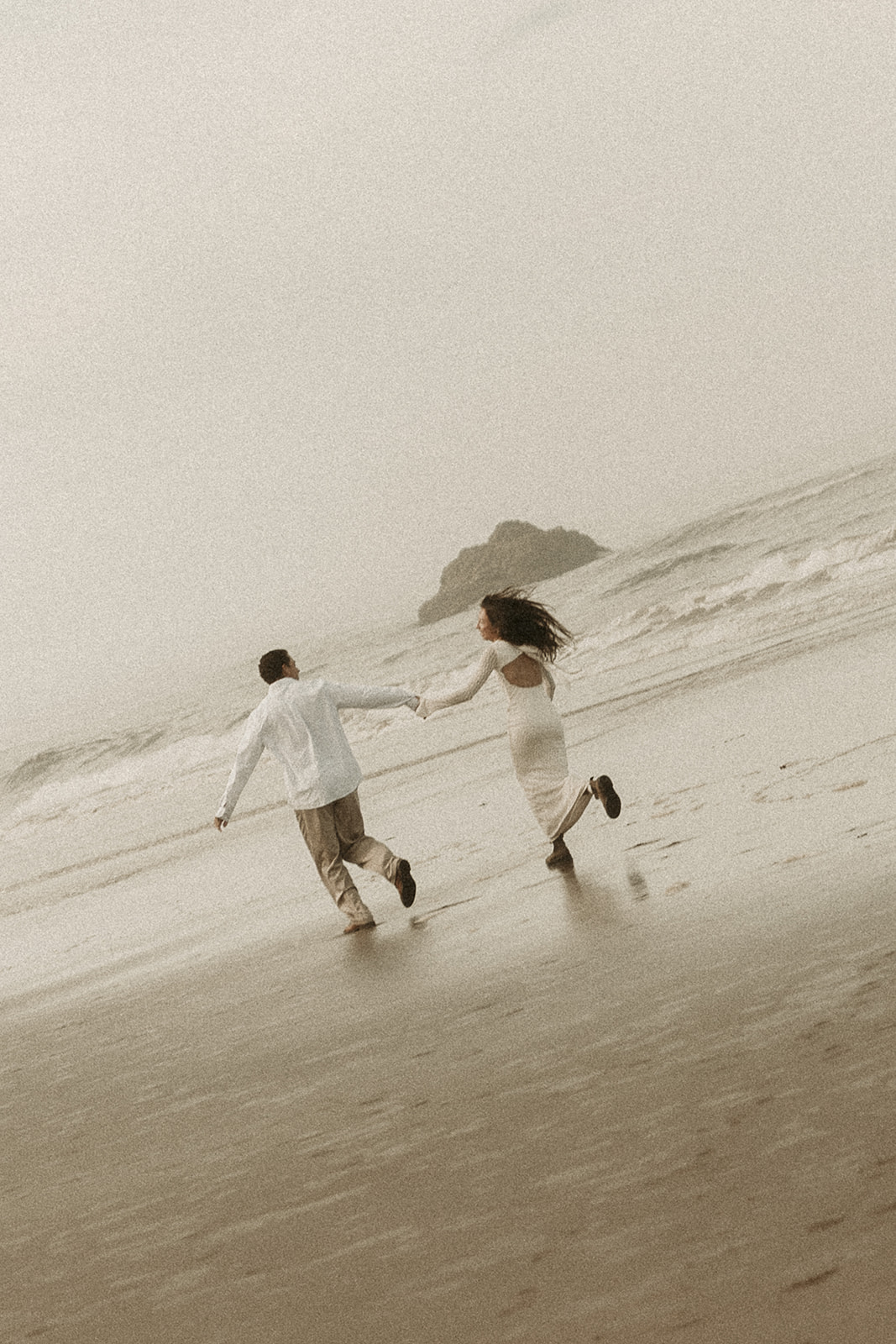 Couple explores Hug Point during their Oregon coast elopement.