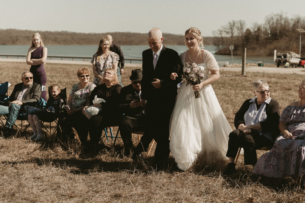 Spring micro wedding at Blue Springs Lake, Missouri. Father walks bride down the isle.
